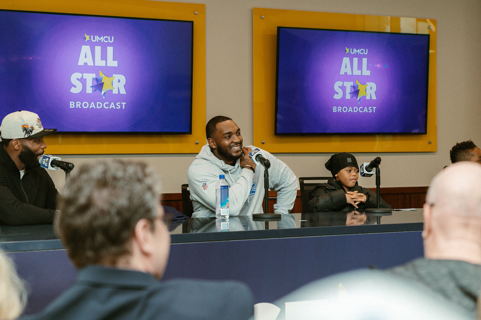 Derrick Moore of the Detroit Lions sitting at a desk.