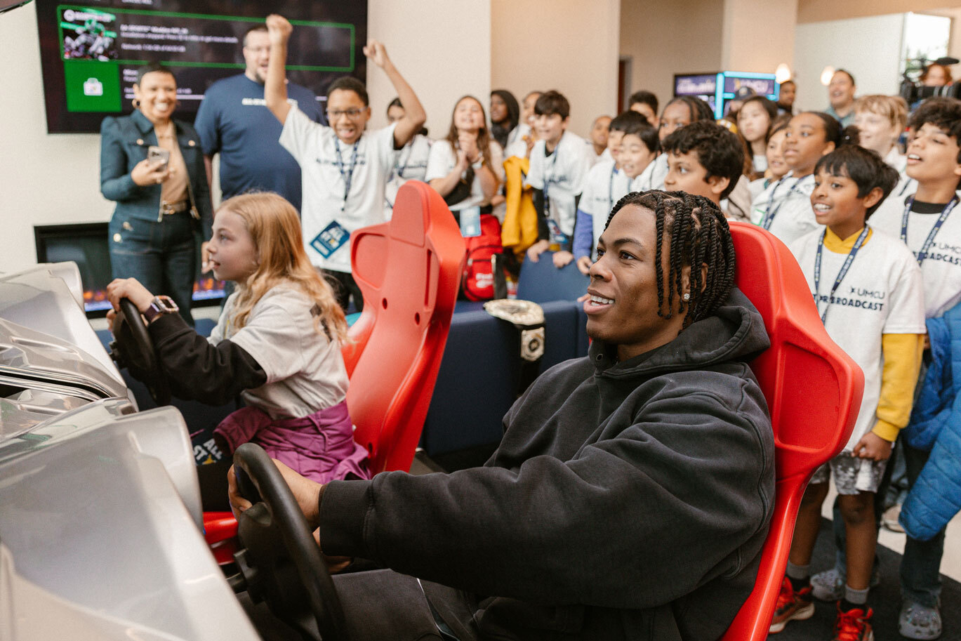 Jahmyr Gibbs of the Detroit Lions plays Mario Kart with children at Plymouth Rd. Branch