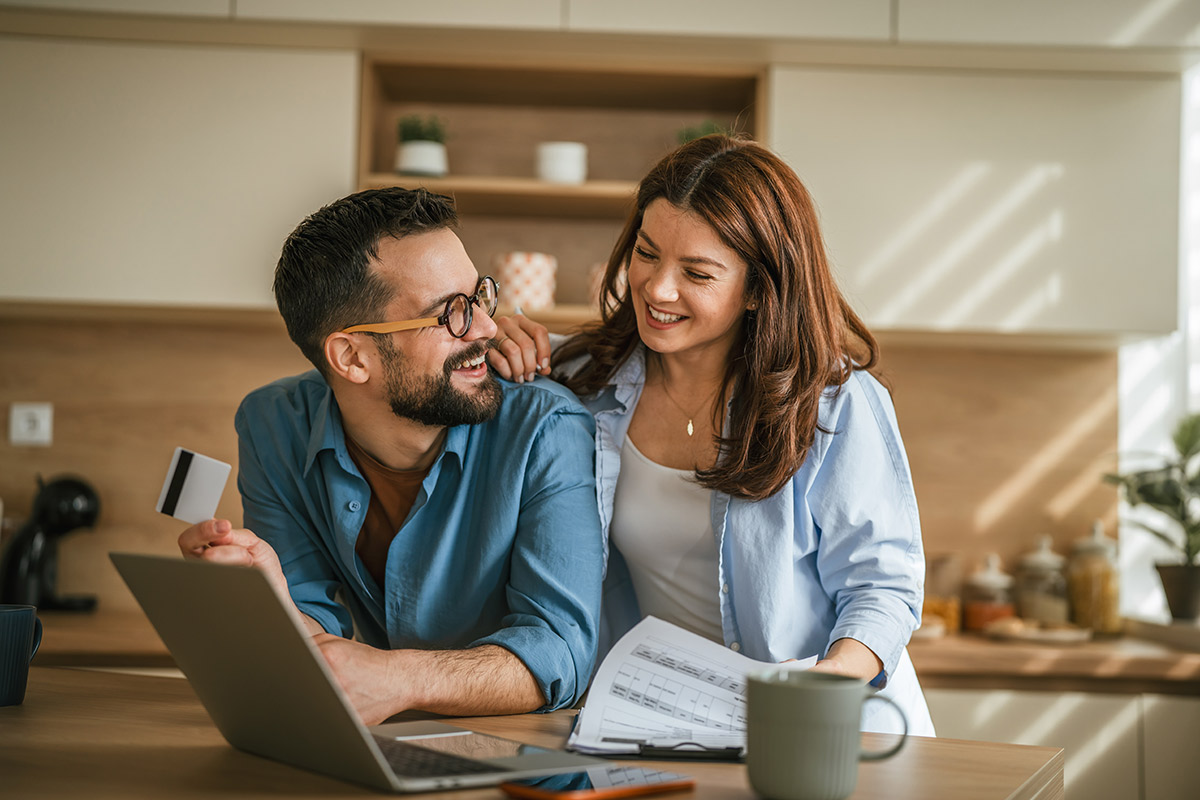 couple in kitchen reviewing their home equity options and smiling